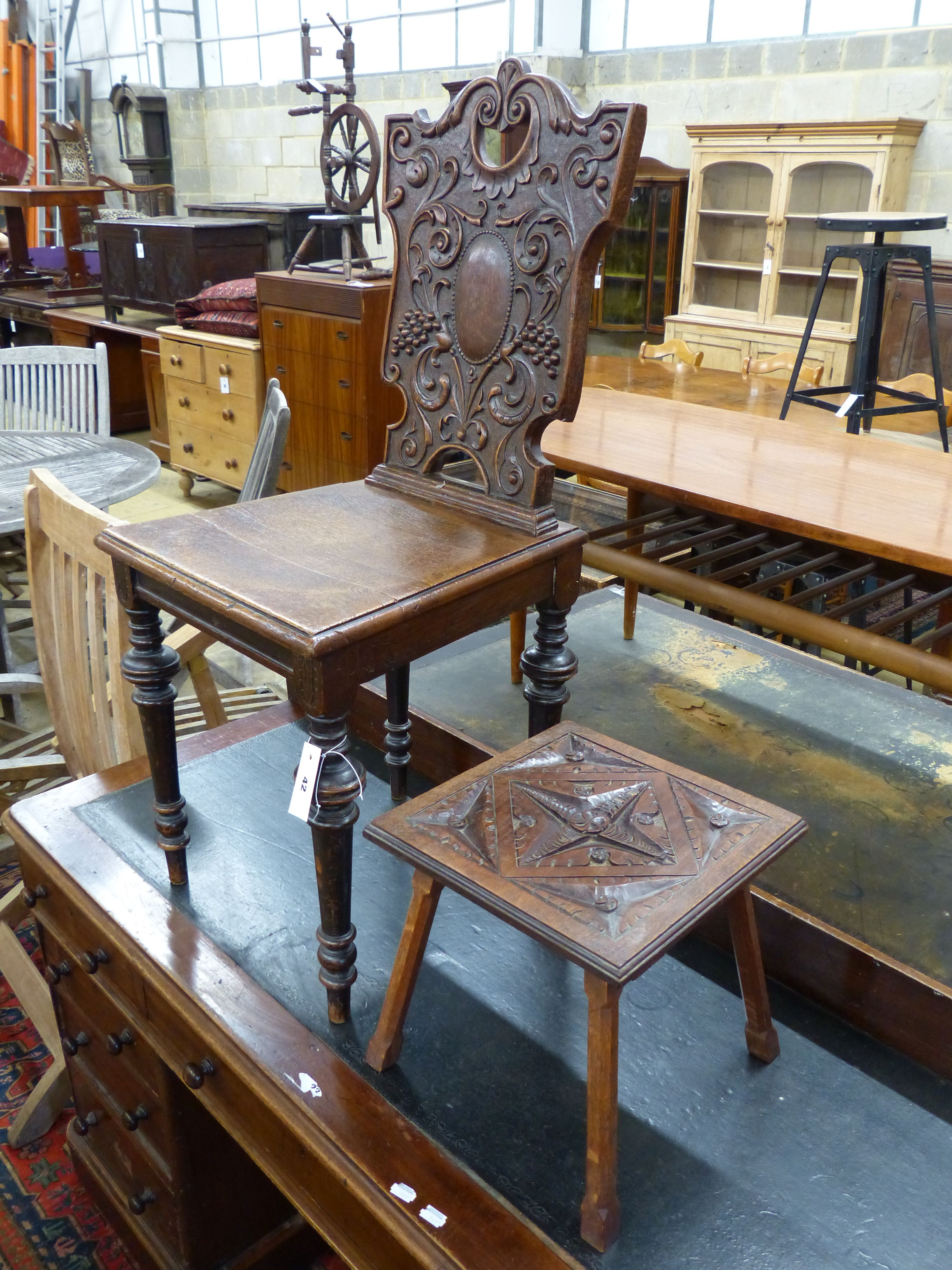 A late Victorian carved oak hall chair and a small occasional table